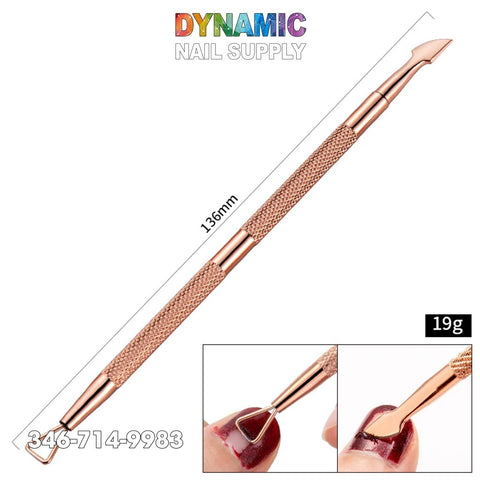 A close-up of the Dynamic Nail Supply Dual-ended Rose Gold Nail Art Cuticle Pusher reveals its stainless steel craftsmanship and textured grip. Measuring 136mm and weighing 19g, this tool excels in nail care by expertly lifting cuticles and cleaning polish. The brand name is presented above in vibrant text.