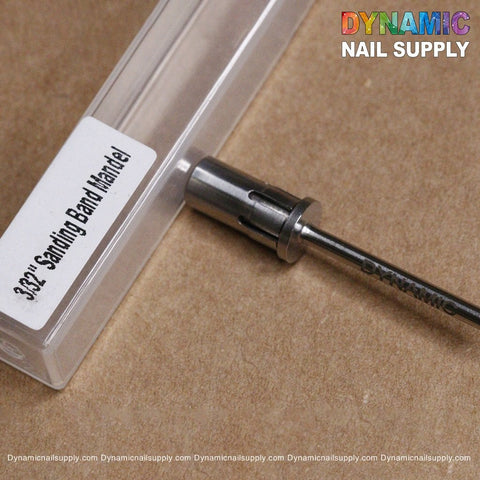 Close-up of a high-quality silver metal sanding band mandrel next to a clear plastic case labeled Easy-Off Sanding Band Mandrel - Remove Sanding Band Faster. The background is a brown, textured surface, with the words Dynamic Nail Supply appearing in colorful text at the top right corner of the image.