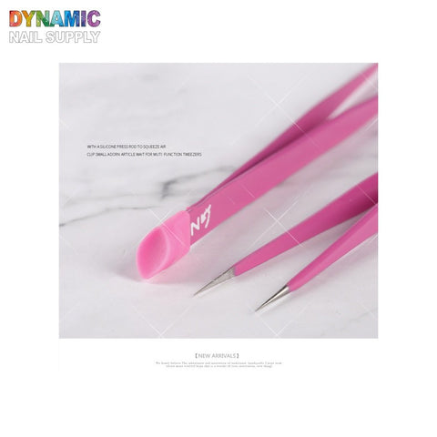 A close-up image showcases the Nails Art Tweezer Double-Head by Dynamic Nail Supply, featuring three pink tools resting on a light background. This set, part of their New Arrivals, includes two precision tips and one with a silicone press tip, all designed for versatile nail art purposes.