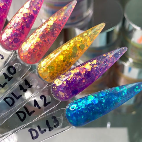 Close-up of five nail polish samples on clear swatches, showcasing Dynamic Nail Supply's New Neon Glitter Acrylic Collection for the Summer 2021. Each sample is filled with chunky glitter in bright coral, yellow-orange, gold with purple, purple, and vibrant blue hues. The swatches are labeled DL10, DL41, DL12, DL13, and DL18 in black marker.