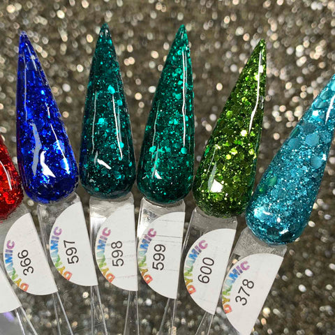 A close-up of five pointed nails featuring the Dynamic Nail Supply's "Holiday Sparkle" Acrylic Powder Collection, perfect for adding a festive touch. The long-lasting glitter polish highlights a sparkly background in colors red, blue, teal, green, and light blue from left to right. Each nail is numbered 596 through 600 for easy identification.